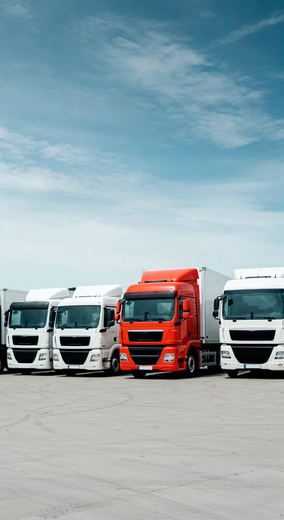 trucks lined up parking lot blue sky